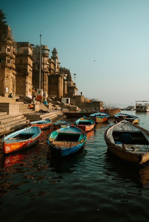 Free A serene view of colorful boats at the Varanasi ghats, capturing India's spiritual essence. Stock Photo