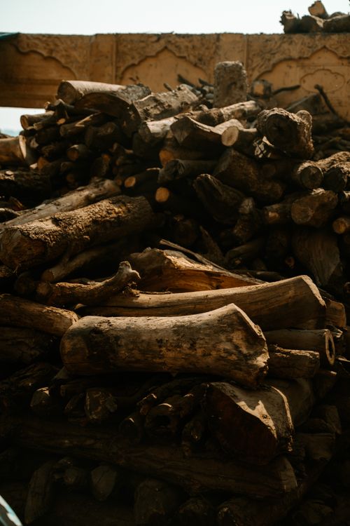 Free A stack of natural firewood logs in a rustic setting, perfect for backgrounds. Stock Photo