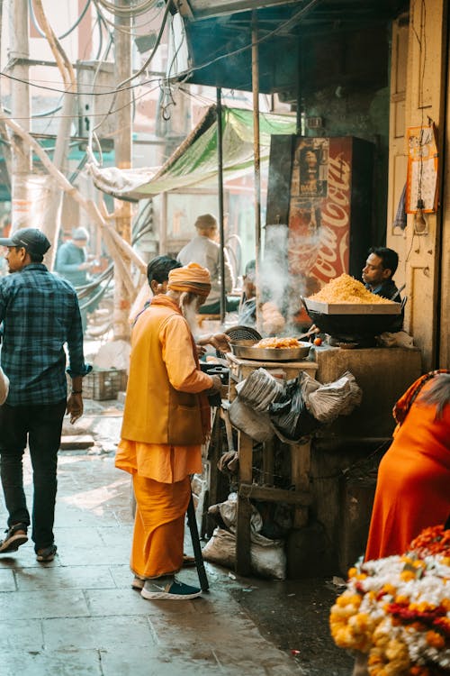 Free Elderly Man Standing by Food Stand Stock Photo