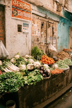 Vibrant market stall in India displaying fresh vegetables and produce on a street.
