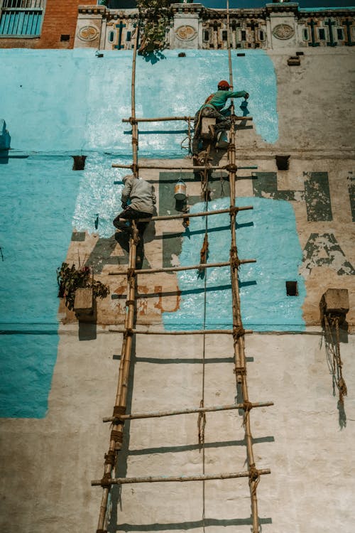 Man Painting the Facade of a Building