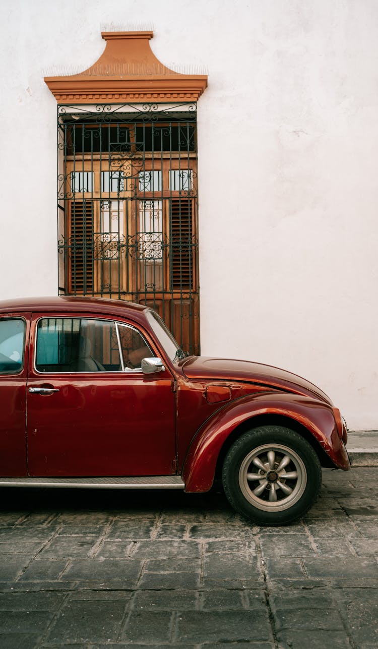 Burgundy Volkswagen Beetle Parked On The Street