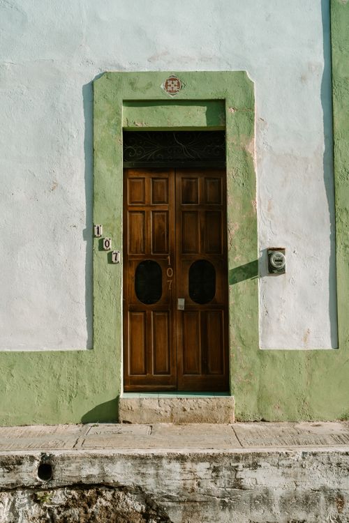 Free An inviting wooden door framed in green, typical architecture of a Mexican town. Stock Photo