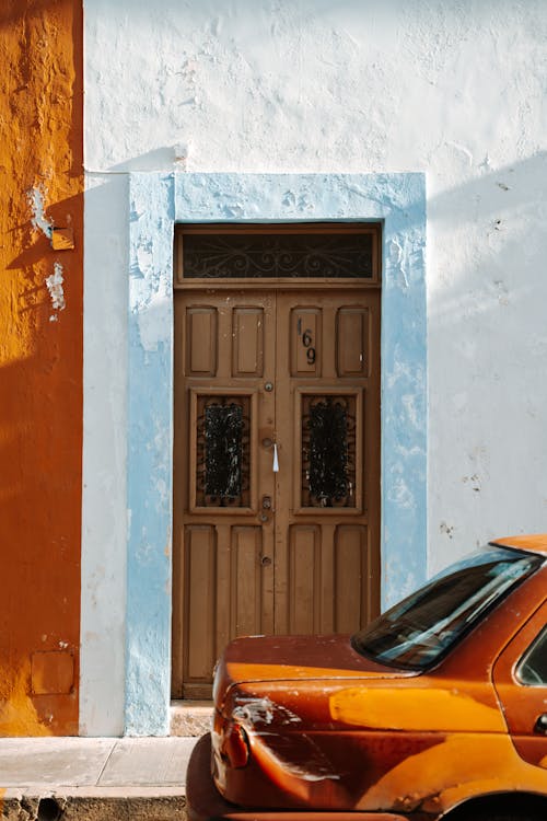 White Facade of a Building and Wooden Entrance Door 