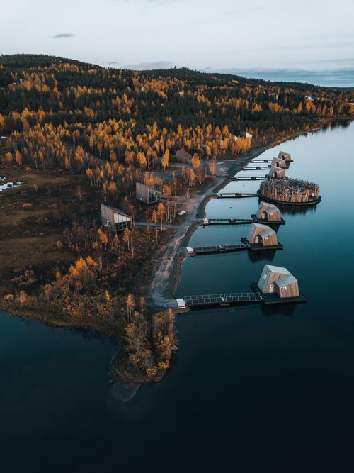 Free A breathtaking aerial photograph capturing the serene lakeshore in Norrbotten County, Sweden during autumn. Stock Photo