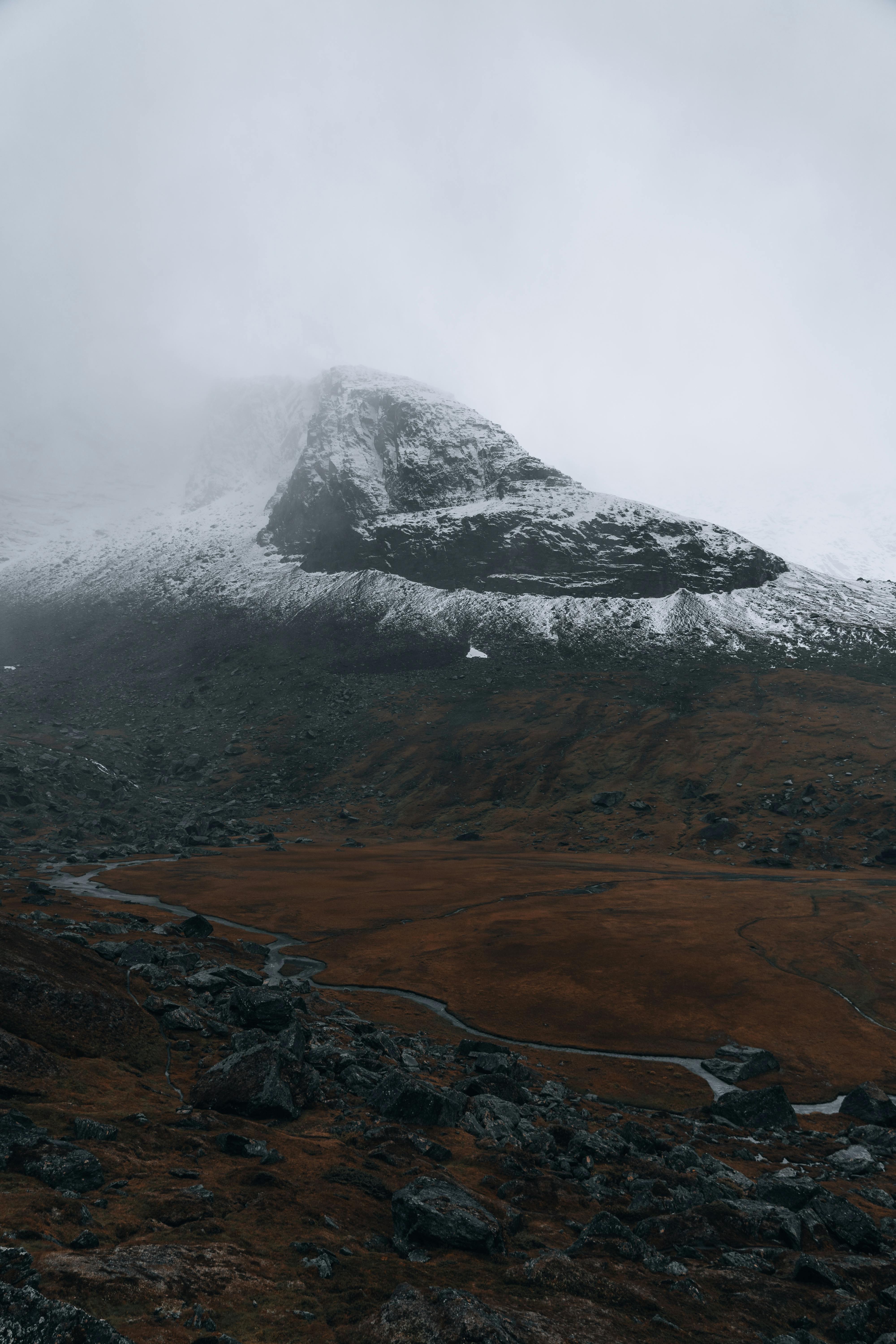 Prescription Goggle Inserts - Dramatic mountain landscape with snow, rocks, and overcast skies creating a mysterious atmosphere.