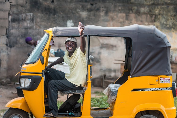 Cheerful Driver Of Three Wheeler Taxi