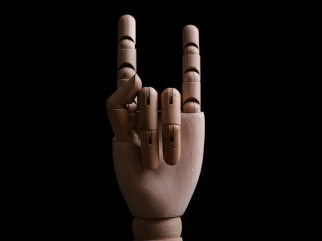A wooden mannequin hand posing in a rock gesture symbol against a dark background.