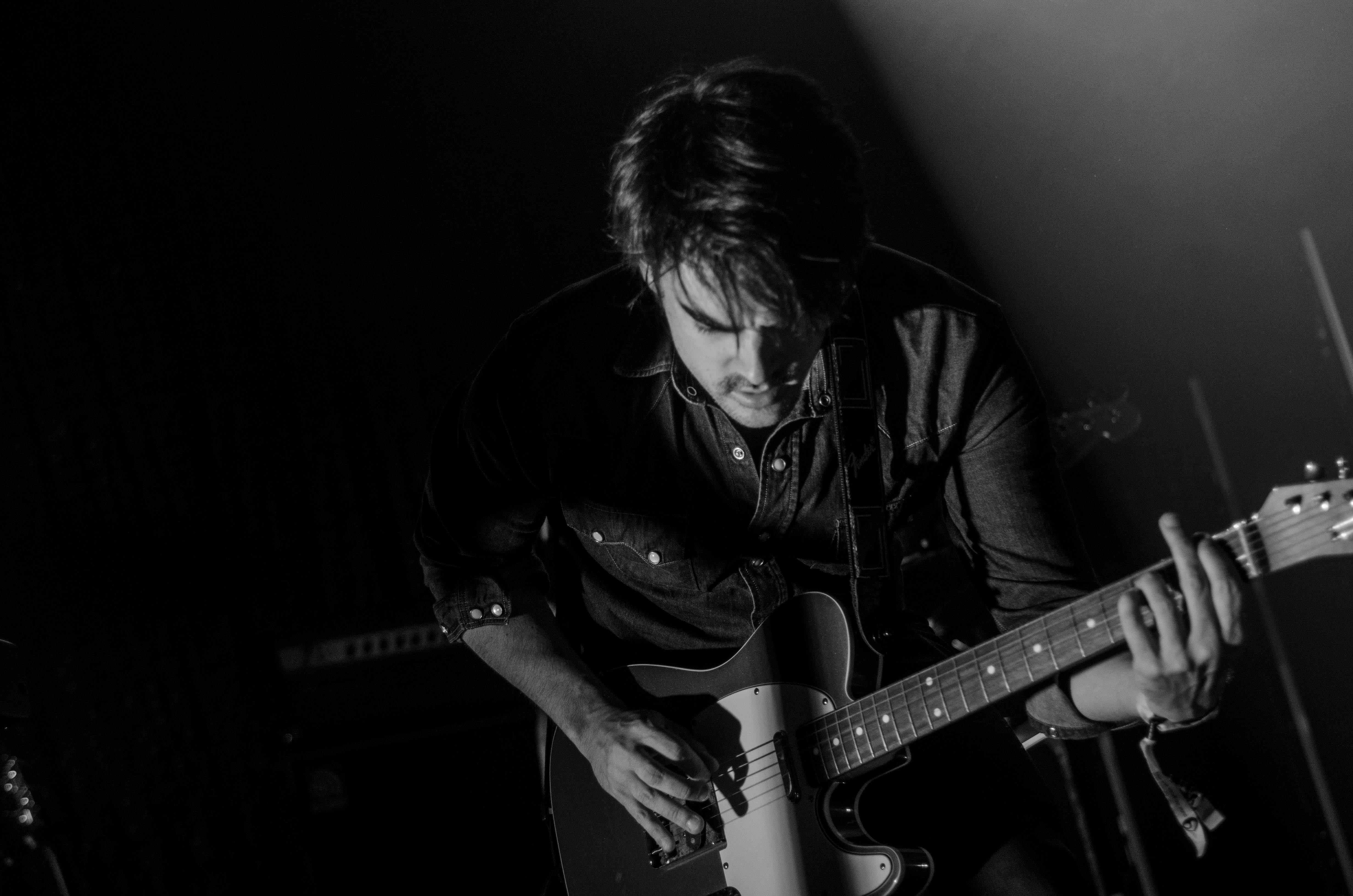 Grayscale Photo Of Man Playing Electric Guitar Free Stock Photo