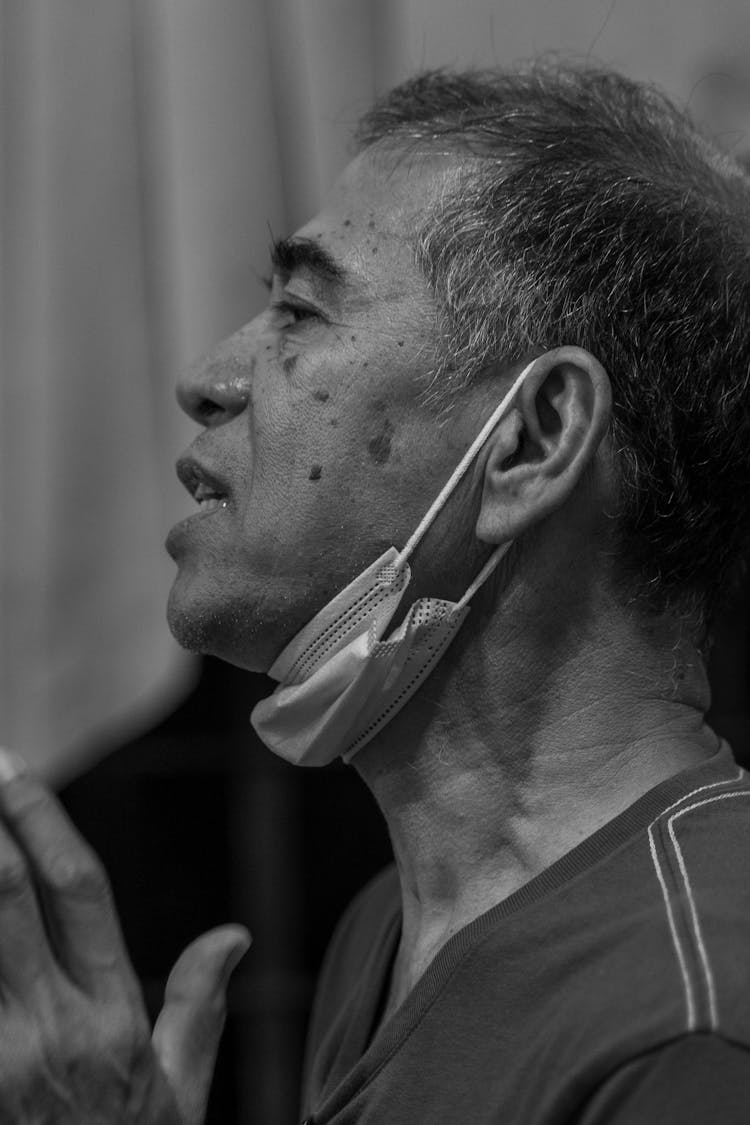 Close-up Side View Of Old Man In Face Mask