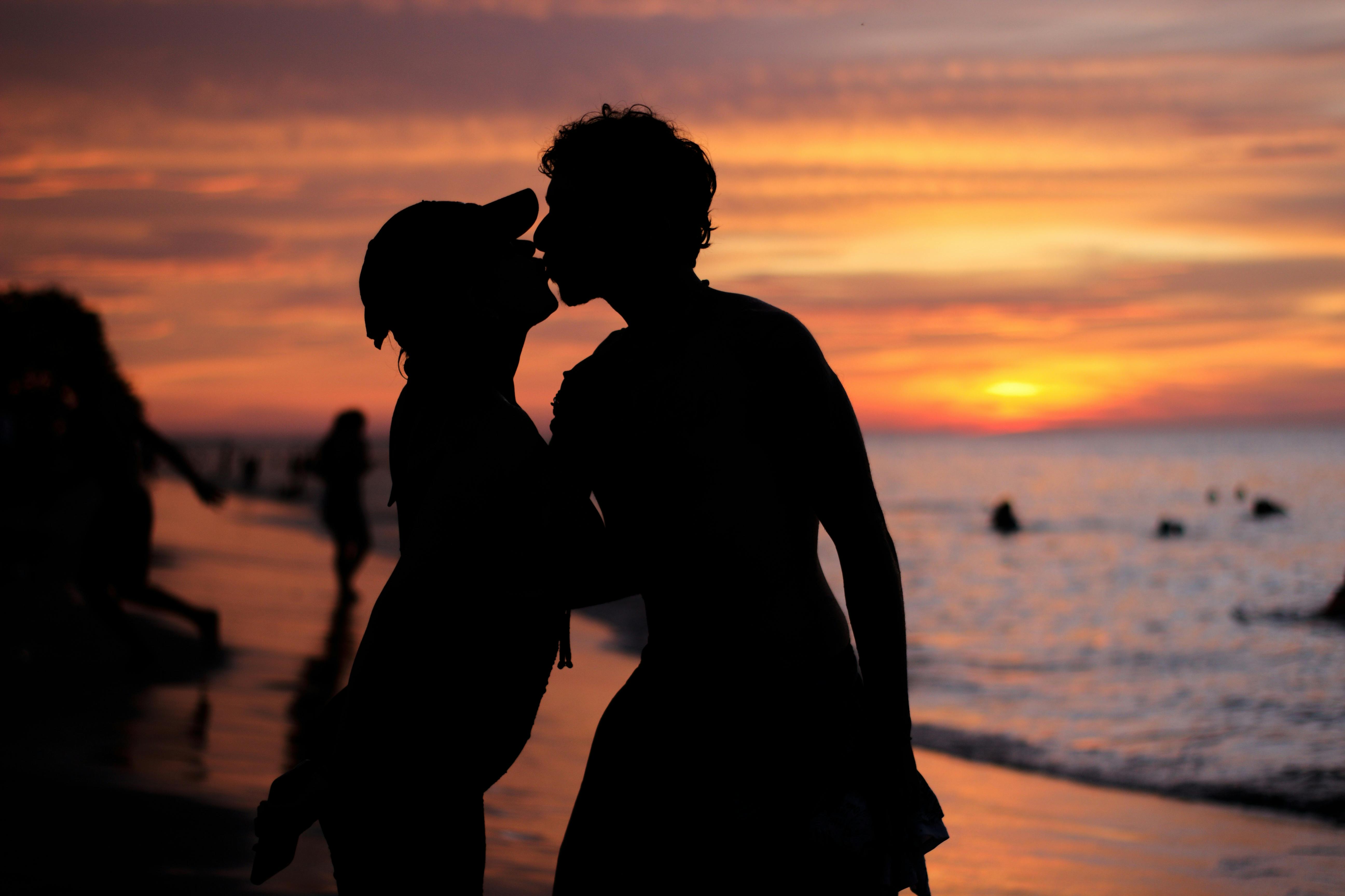 Silhouettes of Couple Kissing on Sunset · Free Stock Photo