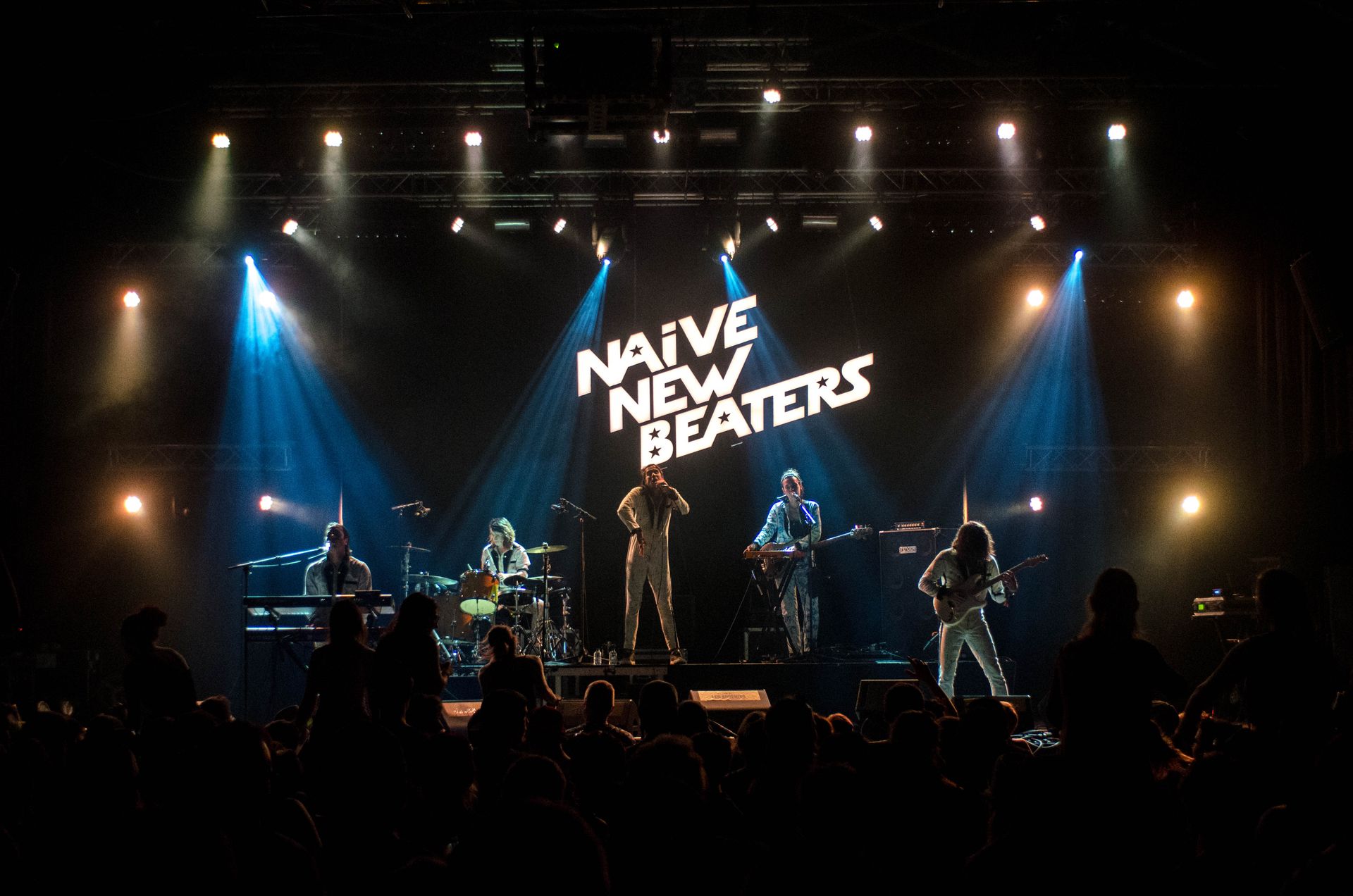 Live band on a stage with dramatic stage lighting