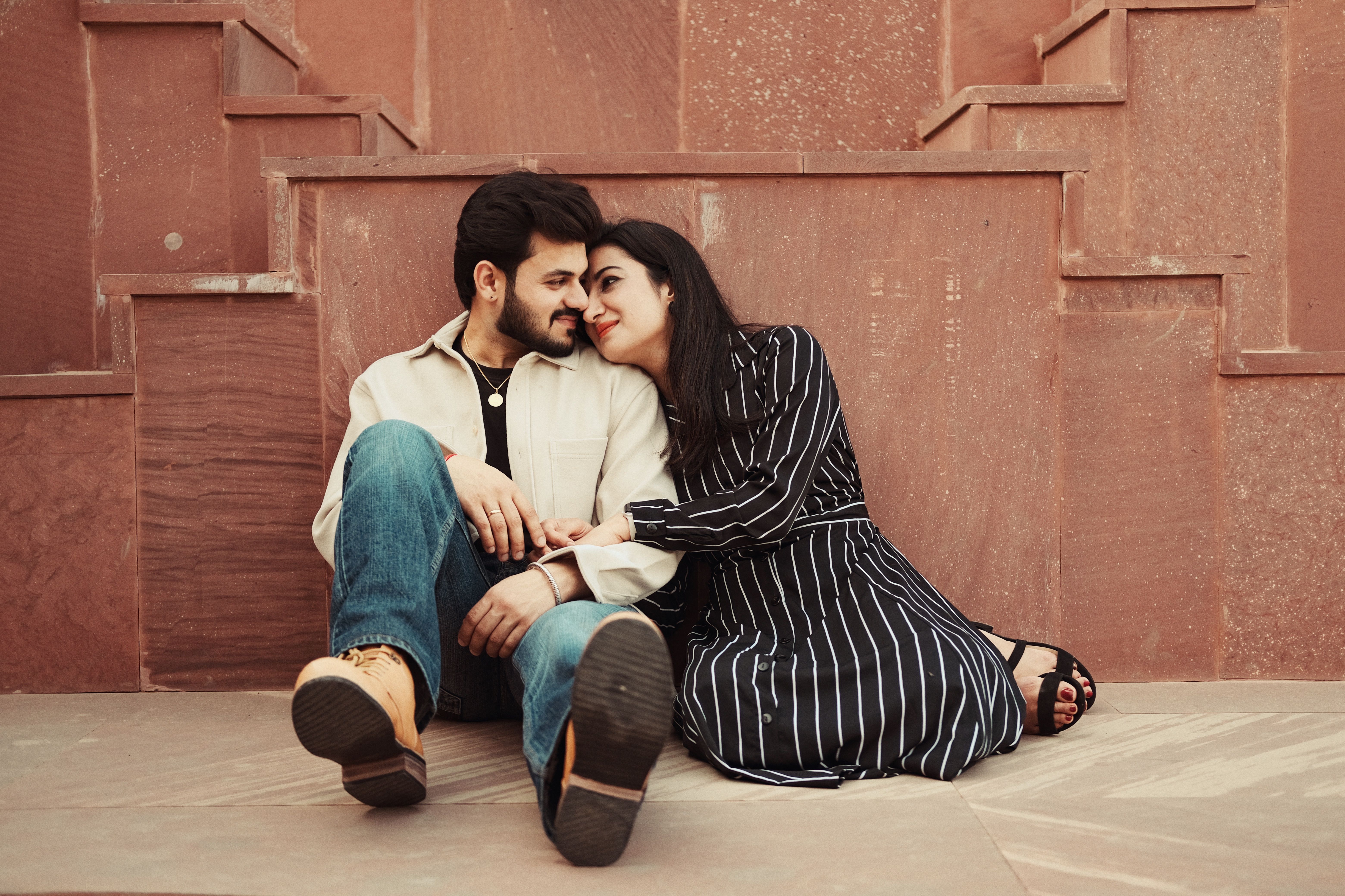 A couple sitting on the steps of a building · Free Stock Photo
