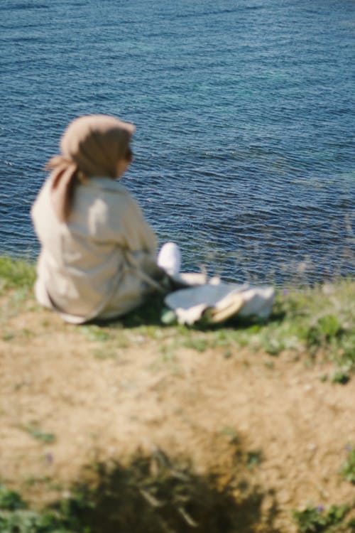 Woman in Hijab Sitting on Grass