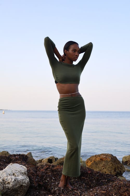 Woman Posing on Rocks on Sea Shore
