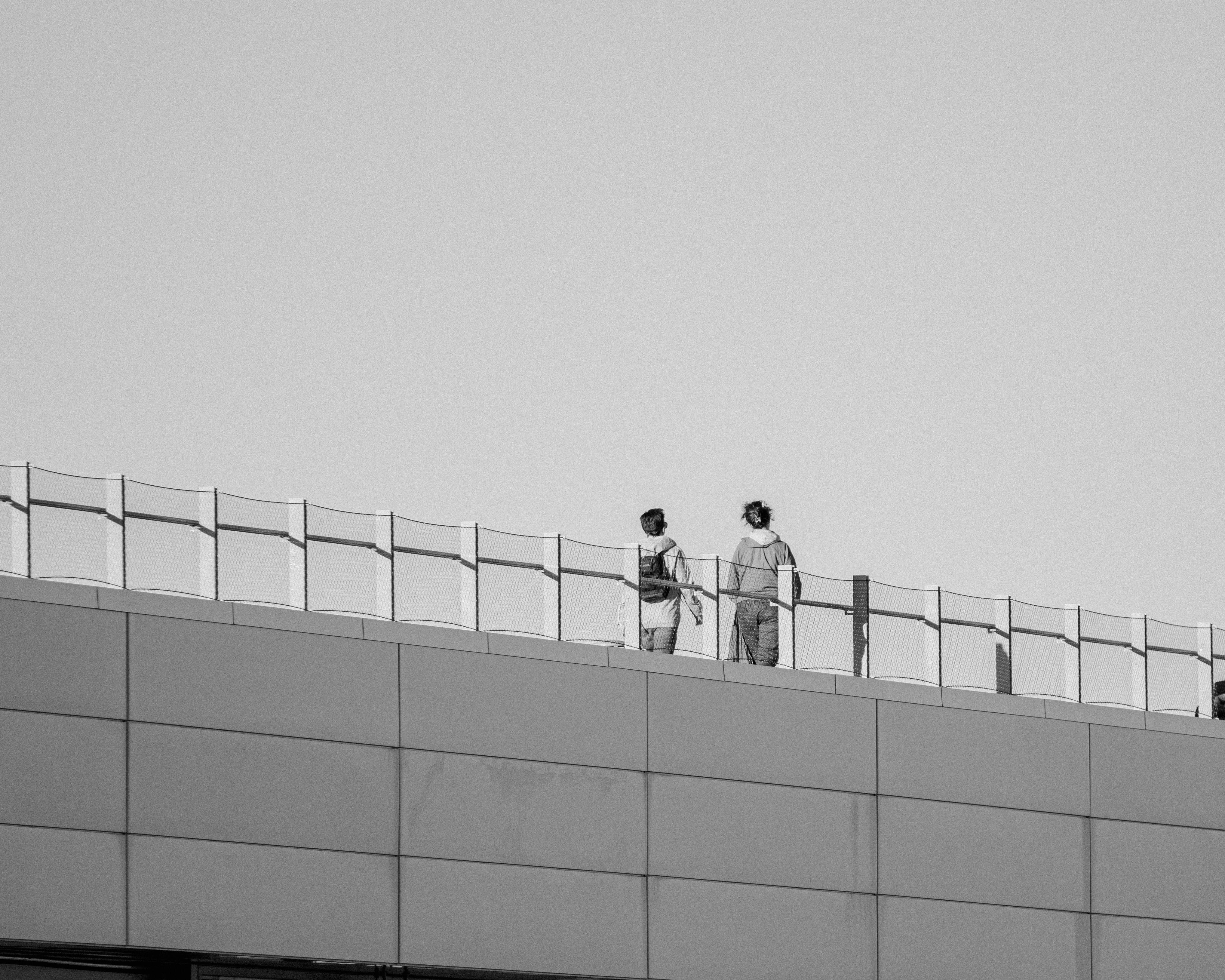 Man Standing behind Building Railing · Free Stock Photo