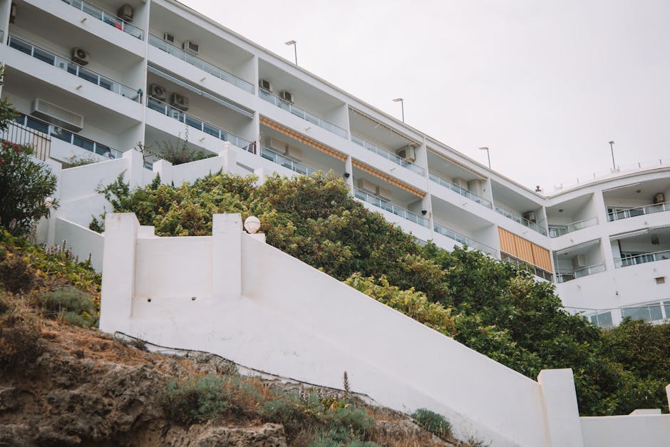 Low angle view of a modern apartment building with white walls in Málaga, Spain.