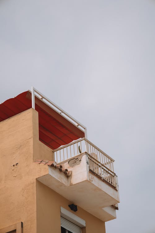 Low Angle Shot of a Residential Building with a Balcony 