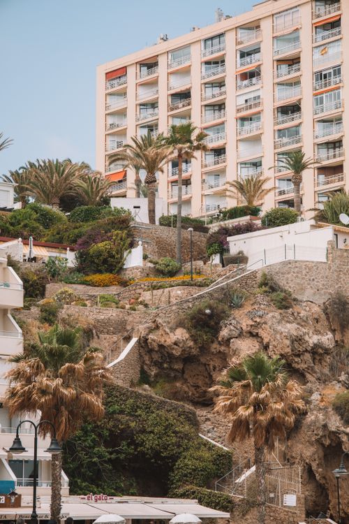 Free Stunning beachside resort in Málaga, Spain featuring lush gardens and palm trees. Stock Photo