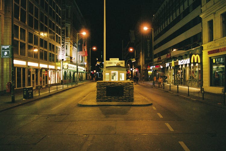 A City Street With Shops And Restaurants At Night 