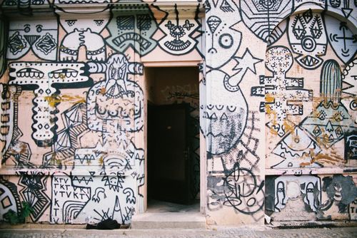 Free Entrance of a Berlin building adorned with eclectic graffiti art, showcasing urban creativity. Stock Photo
