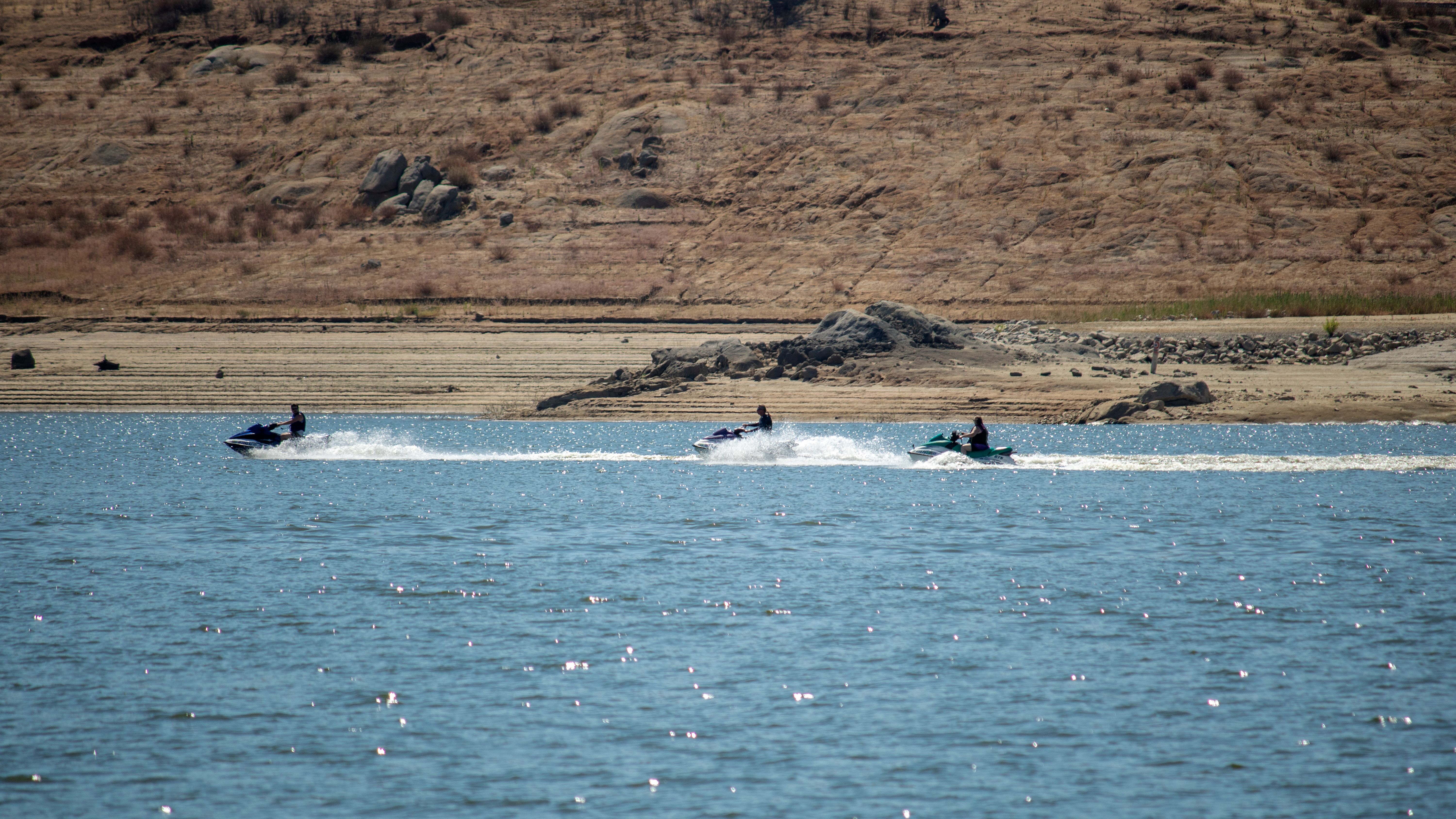 Tourists Racing on Jet Skis · Free Stock Photo