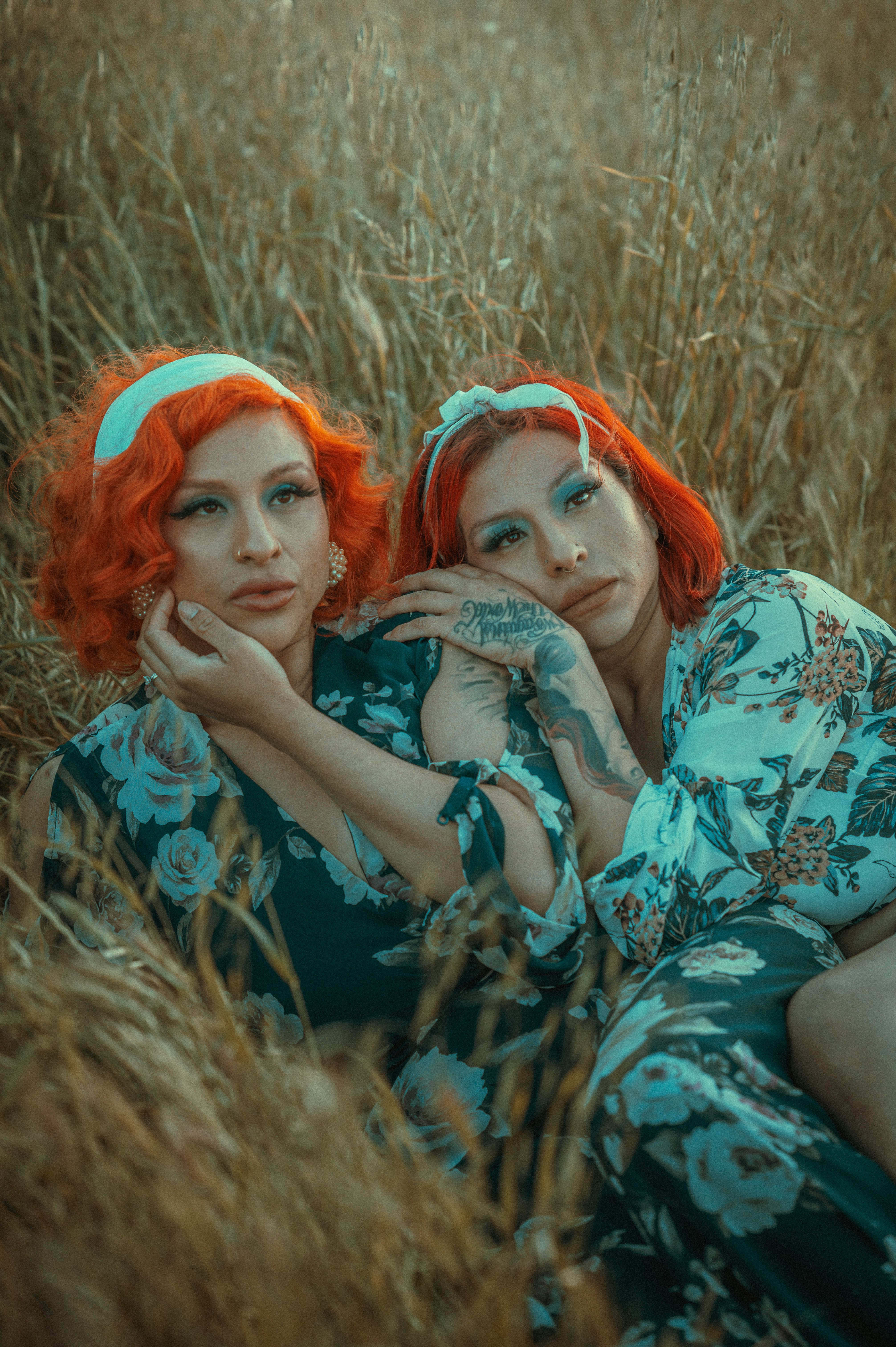 Women Lying Down and Posing Together among Grasses · Free Stock Photo