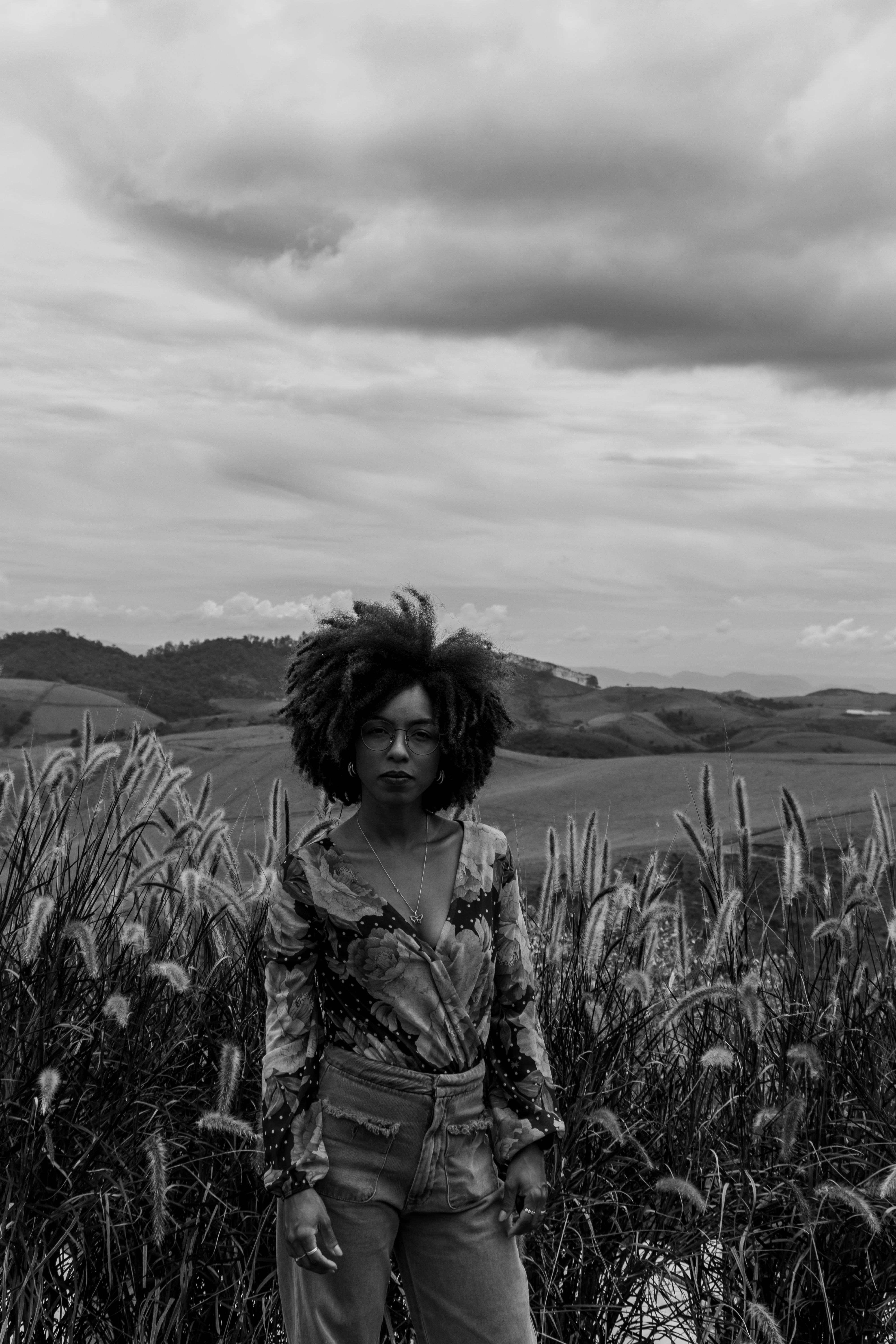 Woman in Curly Hair Posing in Black and White · Free Stock Photo