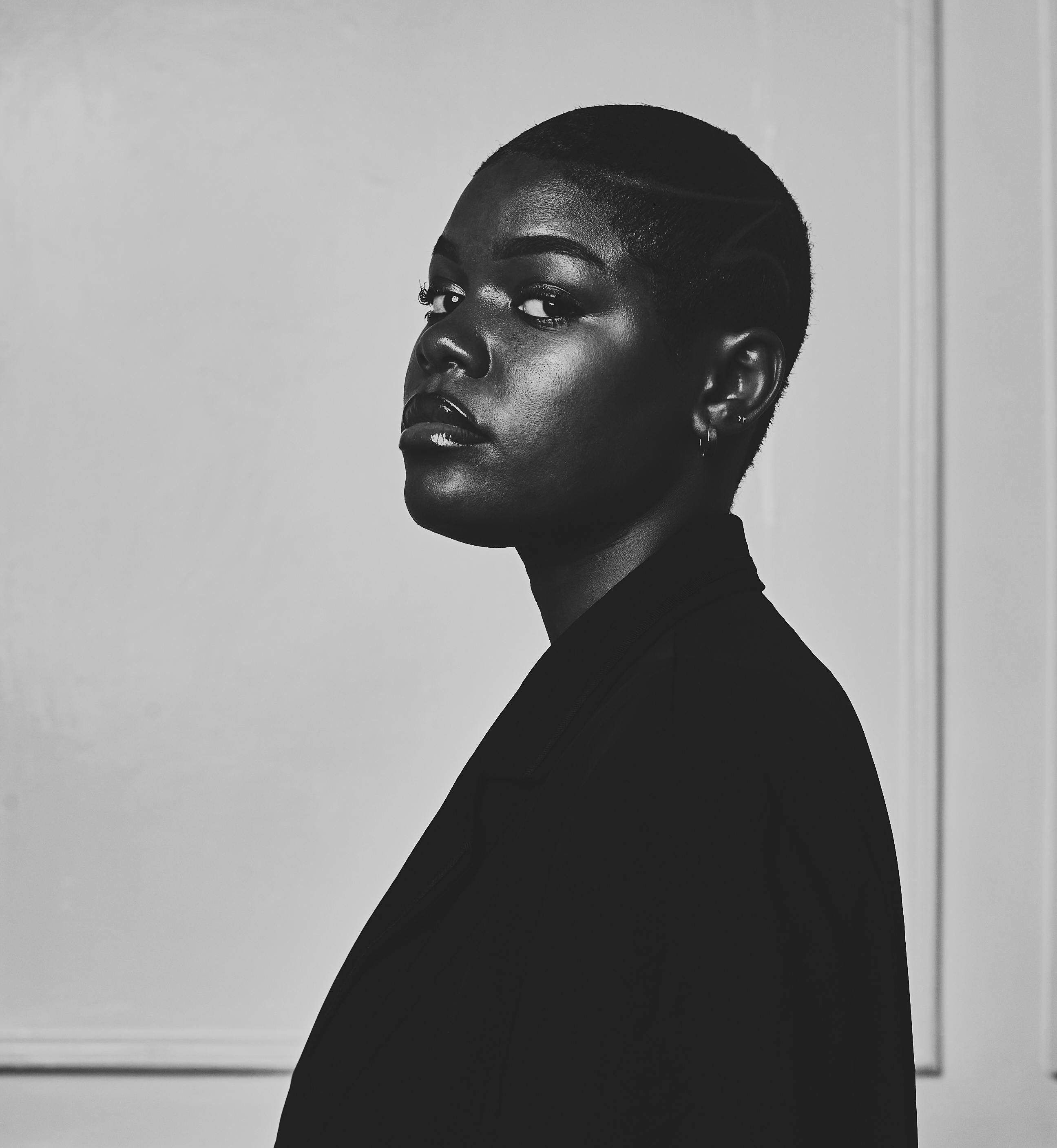 Striking black and white portrait of a woman with short hair in Douala, Cameroon.