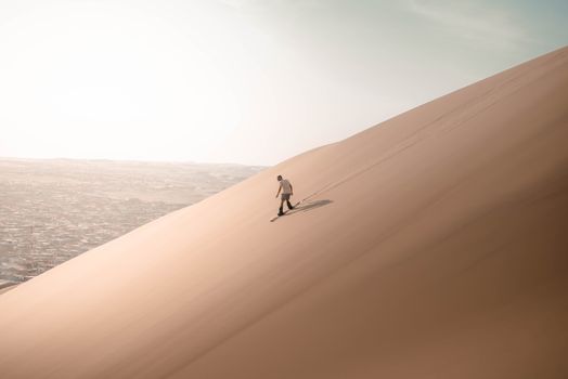 Man Sliding on Desert Dune