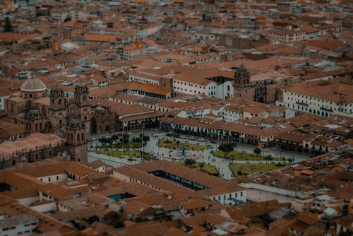 Free Drone view capturing the Plaza de Armas, Cusco, with its historic architecture and vibrant cityscape. Stock Photo