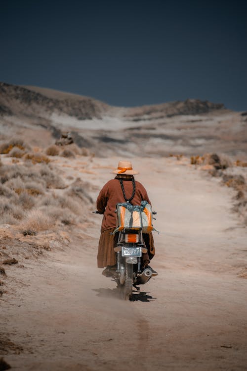 Woman Riding a Motorcycle Through the Desert