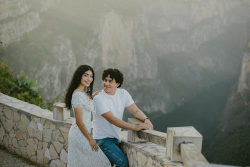 Woman Posing in Dress with Man Posing in Tshirt and Jeans