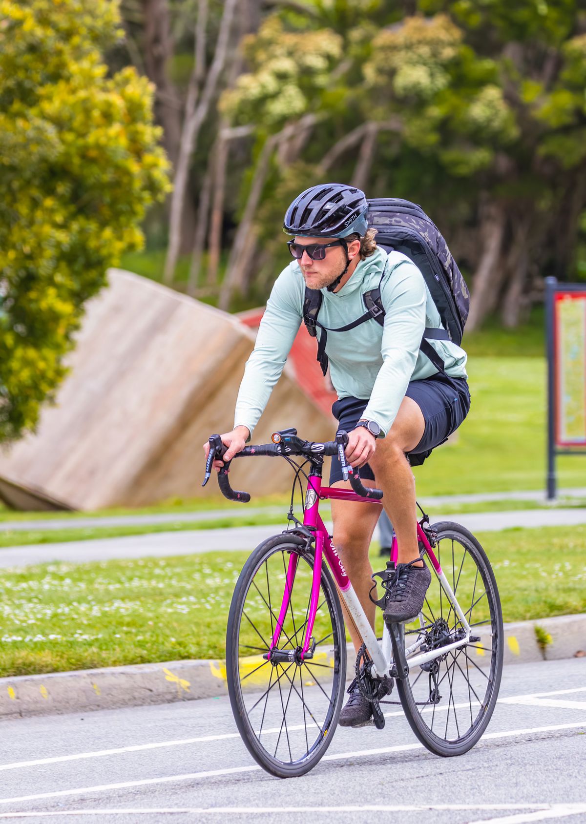 Cyclist wearing a helmet and riding a road bicycle with cycling gear