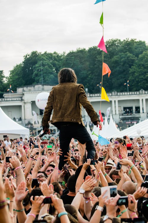 Person Being Carried by Crowd