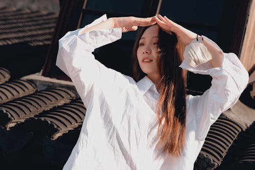 Young Woman on the Background of the Tile Roof