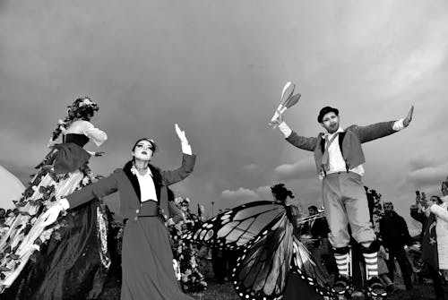 Group of Artists in Stage Costumes Performing in Front of an Audience at a Festival