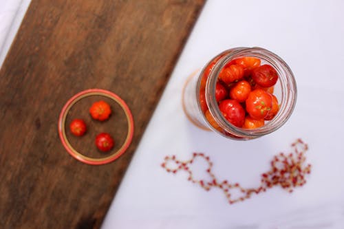 Round Red Fruit on Clear Glass Container