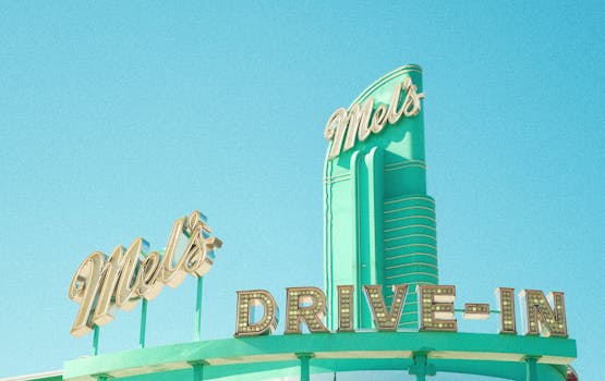 Retro neon sign of Mel's Drive-In against a clear sky in Beijing, China.