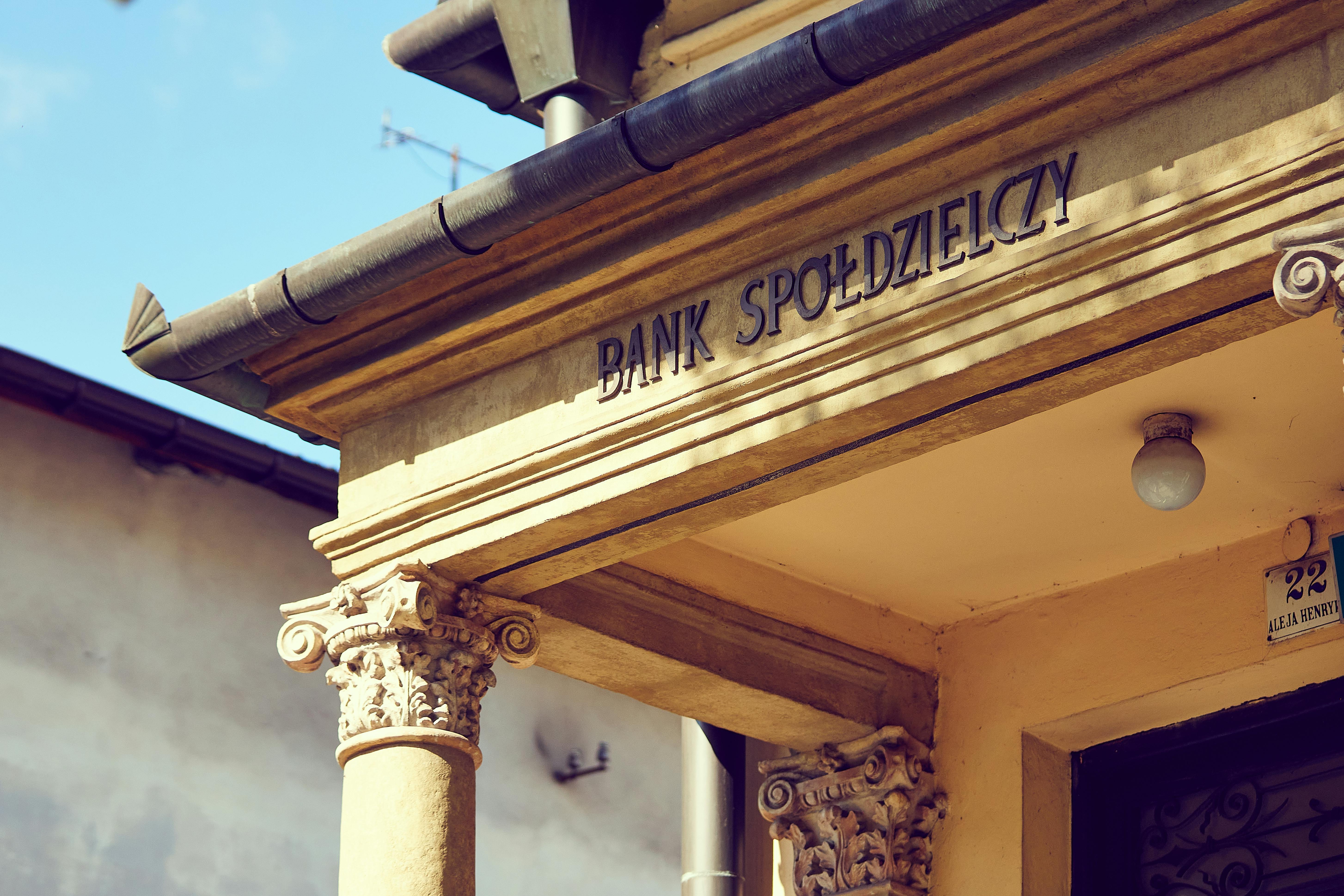 Detailed view of a historic Polish bank facade with classic architectural columns.