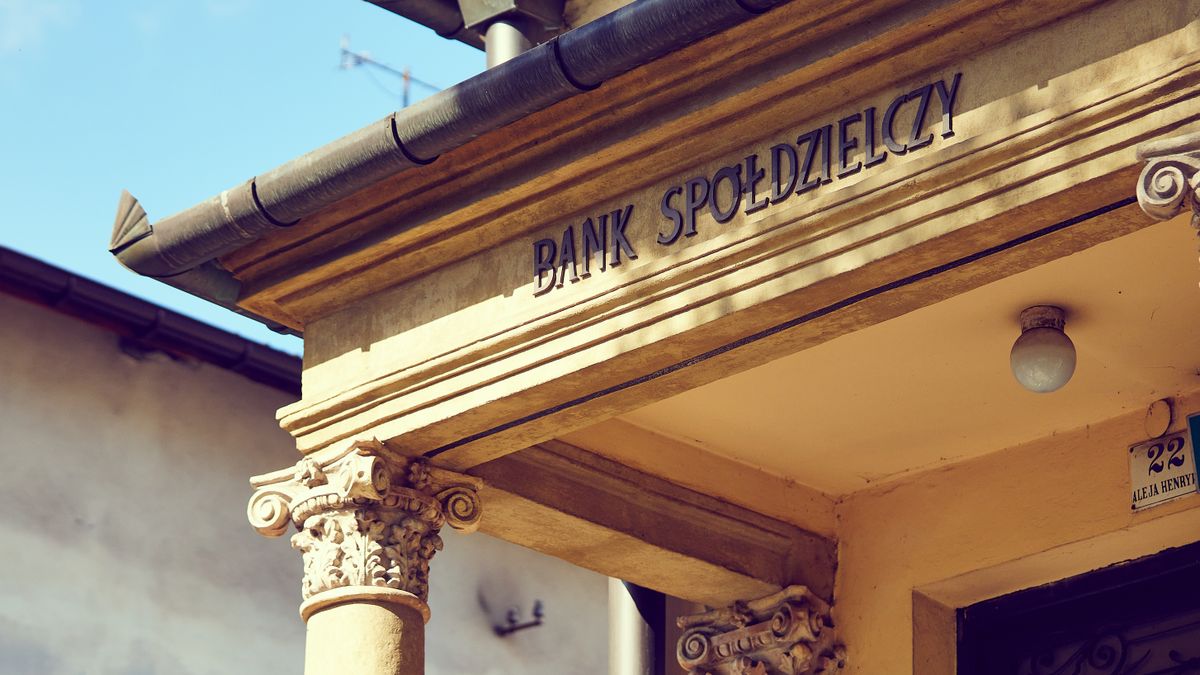 Detailed view of a historic Polish bank facade with classic architectural columns.