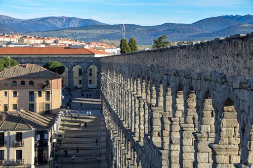Free The iconic Roman aqueduct in Segovia, Spain, with mountains in the background. Stock Photo