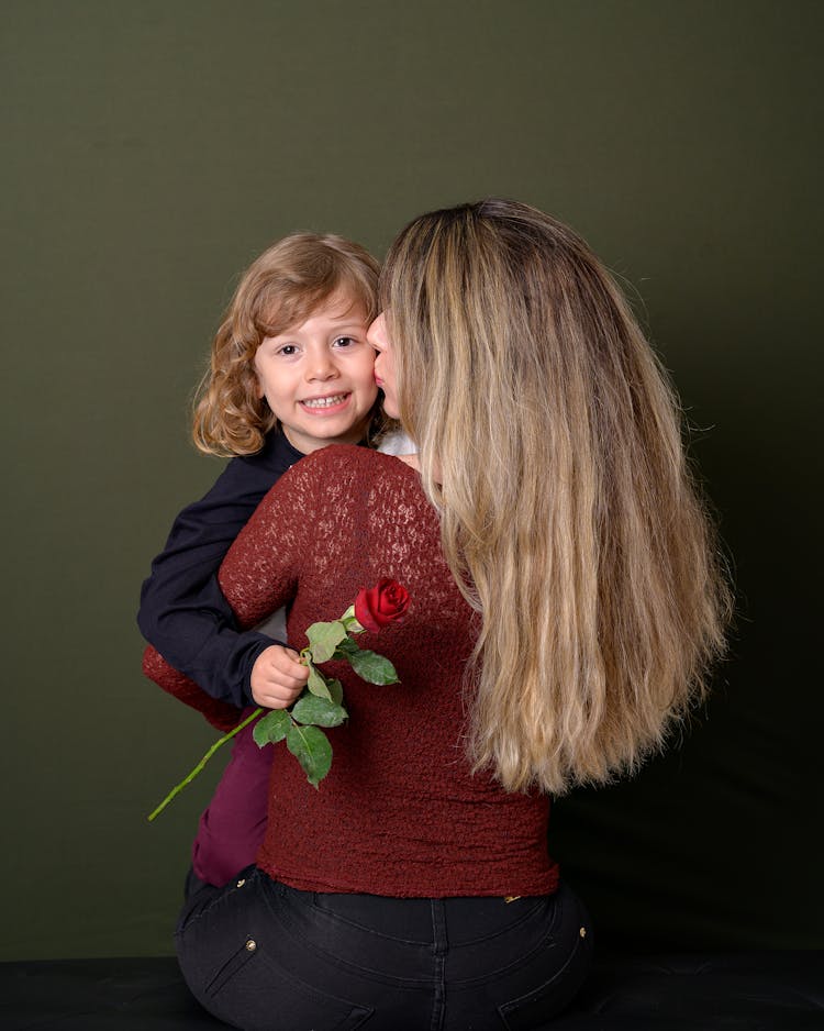 Mother Holding And Kissing Daughter