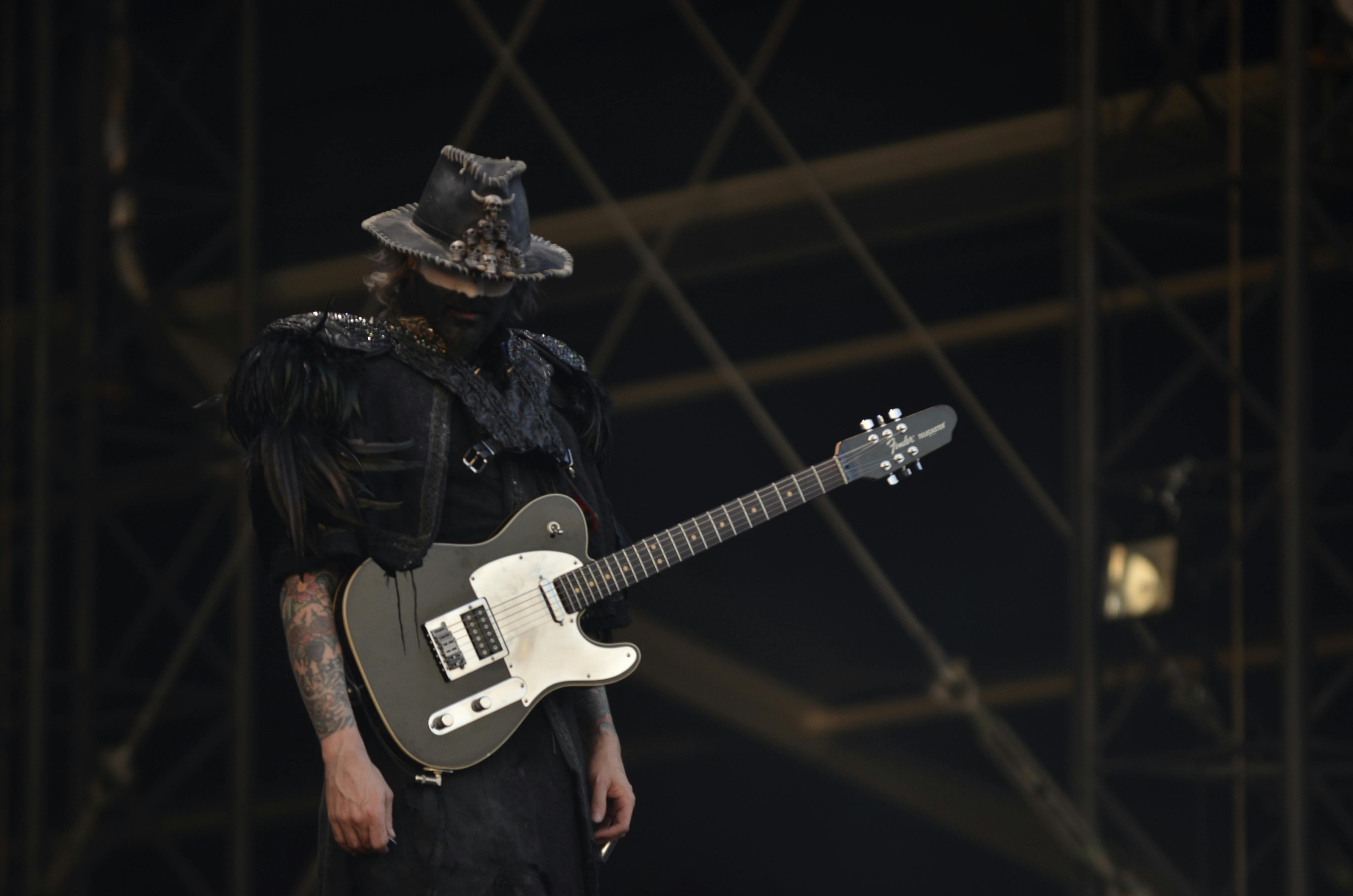 person in black shirt with a black telecaster guitar