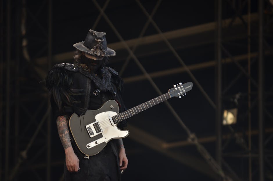 Person in Black Shirt With a Black Telecaster Guitar