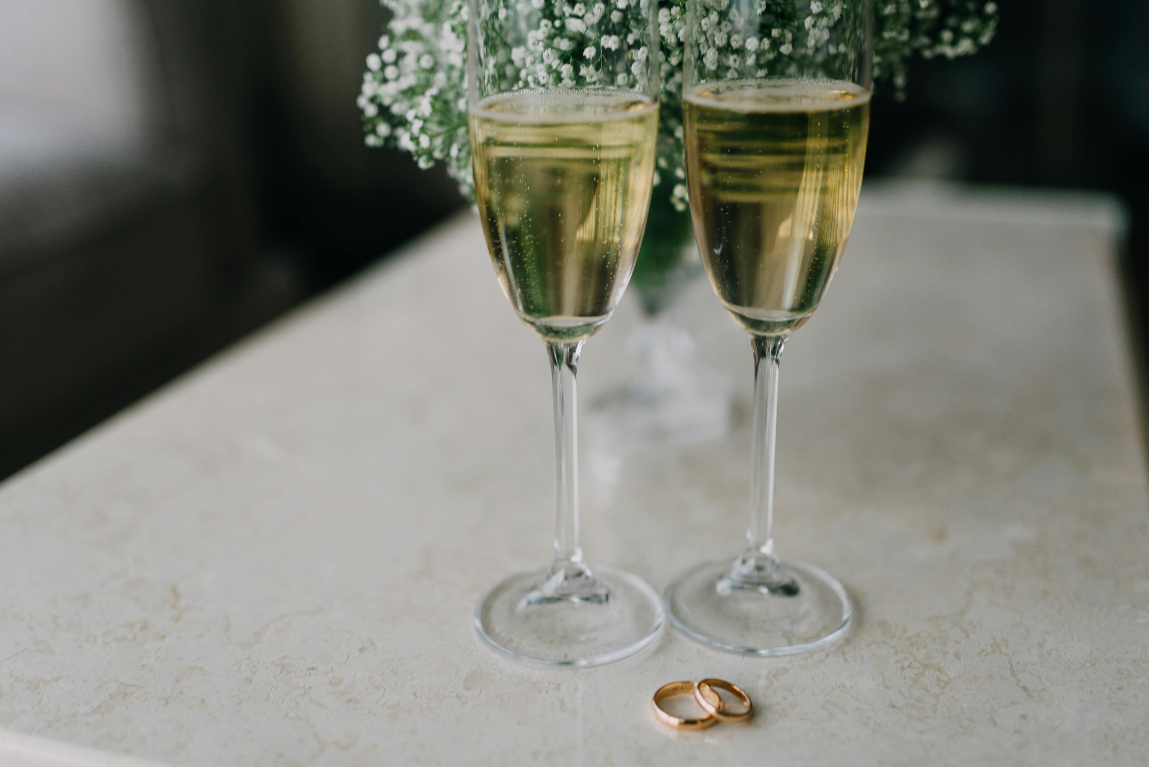 Two Clear Champagne Flutes on White Table