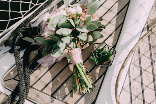 Bouquet of White Flowers Near Fence