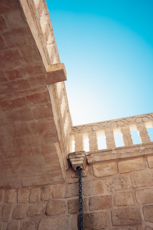 Free Low angle view of historic stone architecture featuring balustrade against clear blue sky. Stock Photo