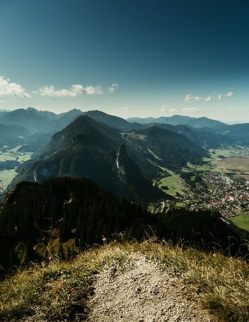 Free Discover the stunning landscape of Garmisch-Partenkirchen with its lush valleys and majestic mountains on a sunny day. Stock Photo