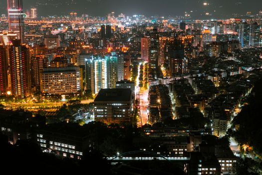 Breathtaking night view of a vibrant city illuminated with modern architecture and bustling streets.